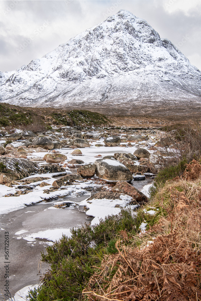 Partly frozen Waterfall on the River Coupall with Buachaille Etive Mor and Stob Deargin the background,  Glen Coe, Highlands, Scotland