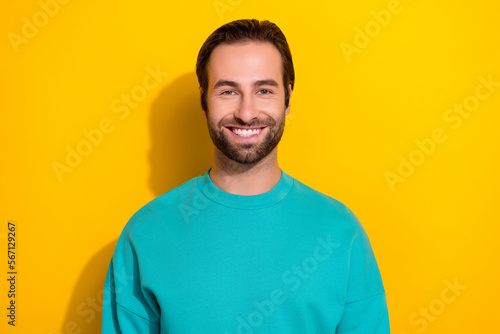 Photo portrait of young positive smile brunet hair attactive student guy wear blue jumper enjoy his freelance job isolated on yellow color background