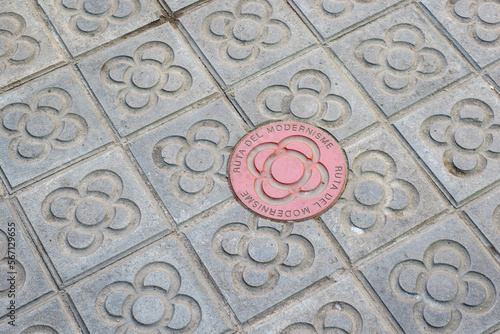 Photography Sidewalk with panot (tiles with flower inside) and the red Ruta Modernista panot
