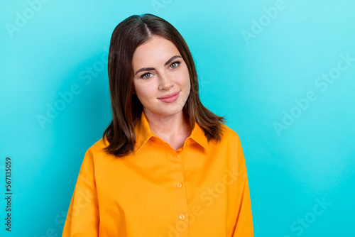 Photo of satisfied gorgeous positive woman with straight hairdo wear yellow shirt look empty space isolated on blue color background