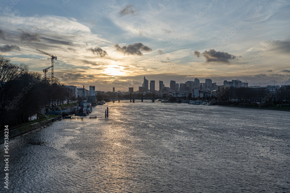 Gennevilliers, France - 01 15 2023: Panoramic view of La Defense towers district from Gennevilliers bridge at sunset