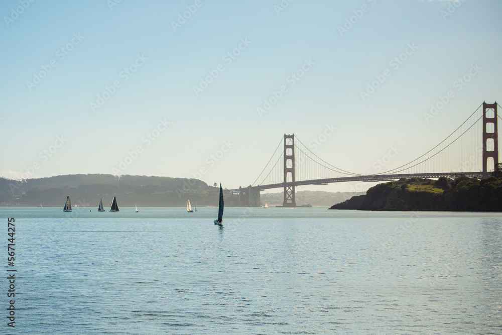Naklejka premium Unusual View of the Golden Gate Bridge and Sailboats.