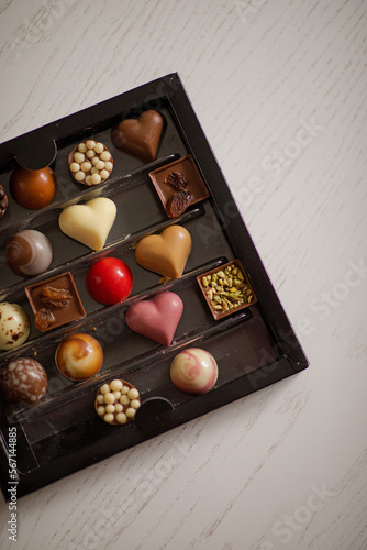 Assorted Valentine’s Day chocolates. Chocolate chocolates in different colors. Heart shaped chocolates. Candy box with sweets .