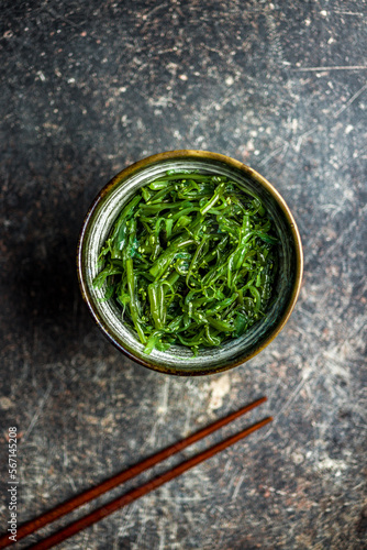 Green seaweed. Japanese wakame salad in bowl. Top view.