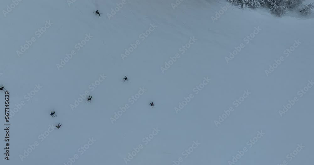 Many skiers and snowboarders skiing down on snowy mountainsides slopes in mountains at ski resort in winter. Family and friends have fun on fresh snow sliding. Bjelasnica mountain. Many skiers and snowboarders skiing down on snowy mountainsides slopes in mountains at ski resort in winter. Family and friends have fun on fresh snow sliding. Bjelasnica mountain.