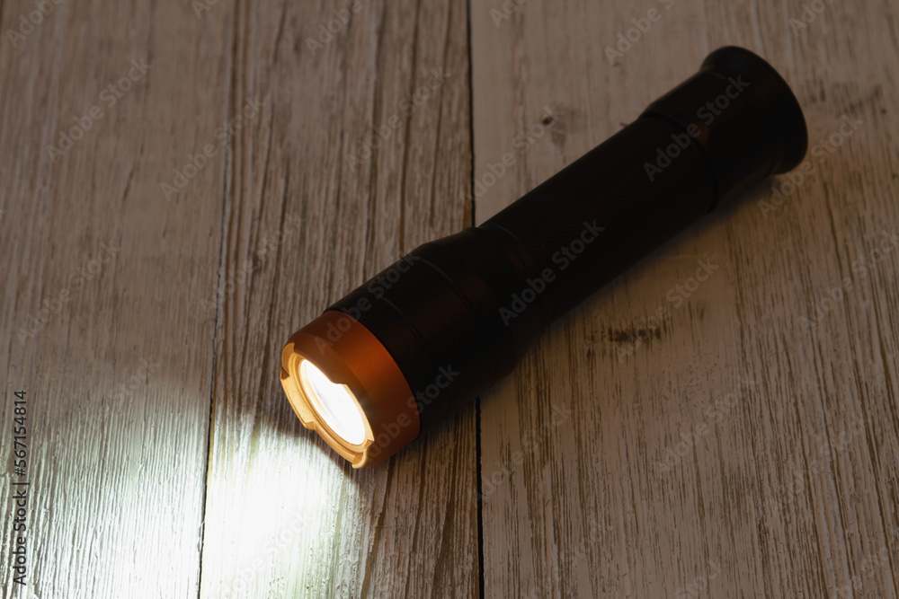LED flashlight on wood table