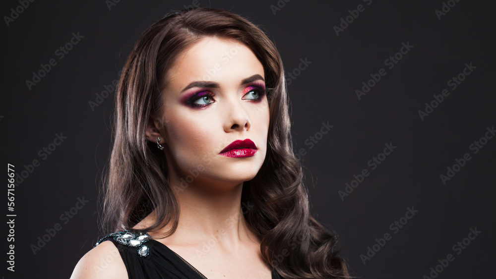 Gorgeous young brunette in a chic evening look. Scarlet lips and eye shadow, wave hair styling Gorgeous young brunette in a chic evening look. Scarlet lips and eye shadow, wave hair styling