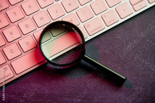 Metaverse. Magnifying glass and laptop keyboard. Seo.