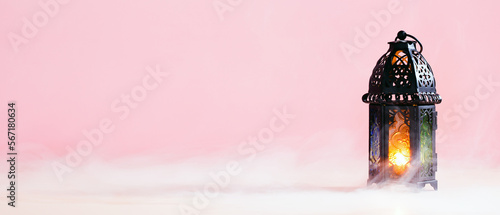 Photography Ramadan Kareem banner design with lantern on pastel pink background with smoke