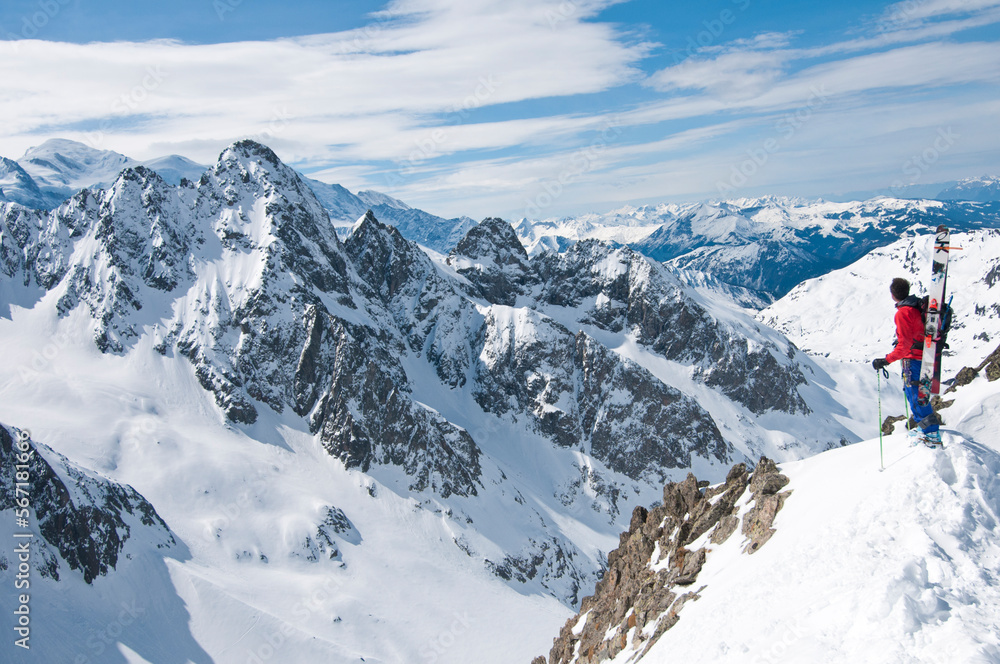 Skier looking at view of Aiguilles Rouges, Chamonix, Haute-Savoie, France Skier looking at view of Aiguilles Rouges, Chamonix, Haute-Savoie, France