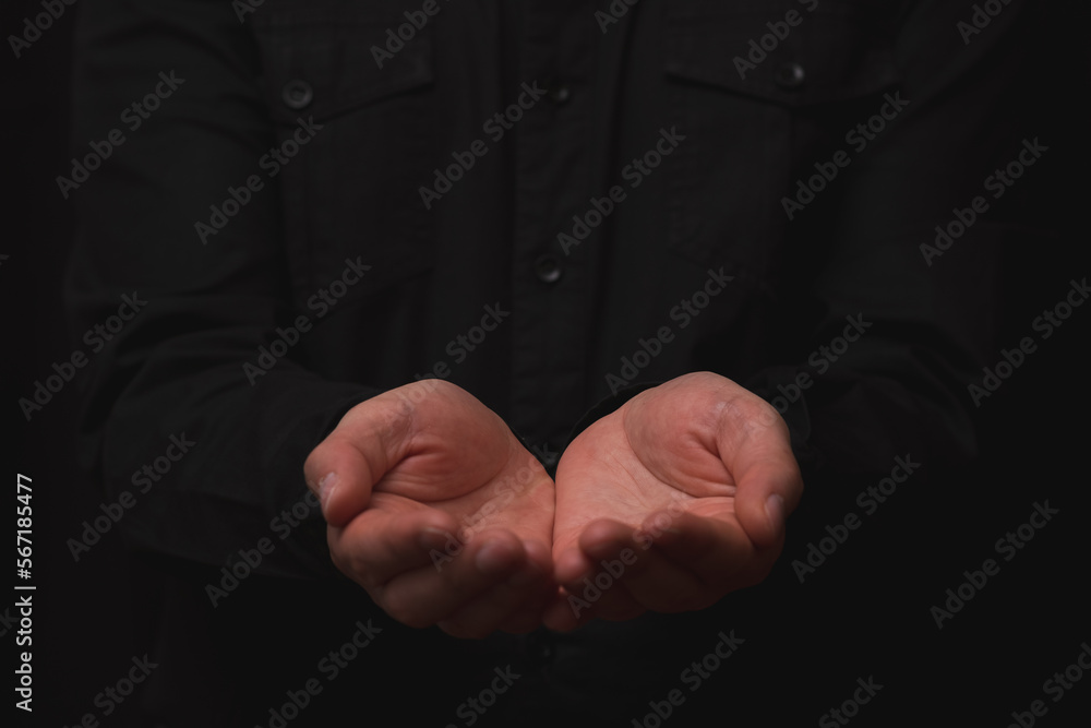 businessman with hands in receiving position with shirt and black background.