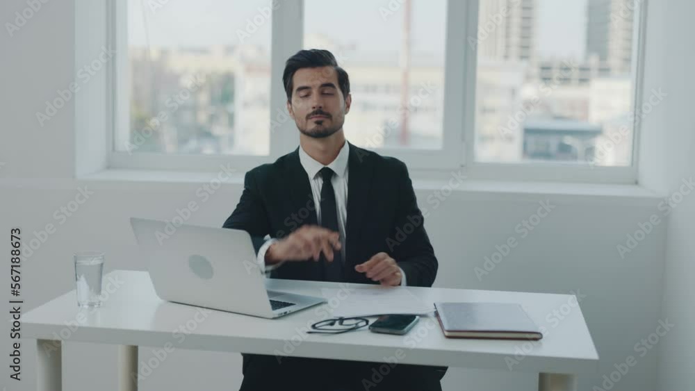 Man business sits at his desk in the office with a laptop and documents and phone smile, working with online information and data processing, closing the deal. Man business sits at his desk in the office with a laptop and documents and phone smile, working with online information and data processing, closing the deal.