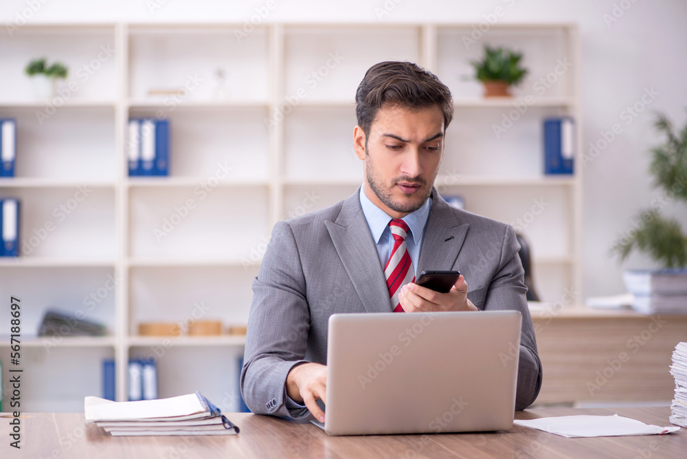Young male employee working in the office Young male employee working in the office
