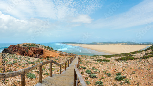 Summer Atlantic coast and lookout point at sandy beach Praia da Bordeira near river estuary. Misty view (Carrapateira, Algarve, Portugal).