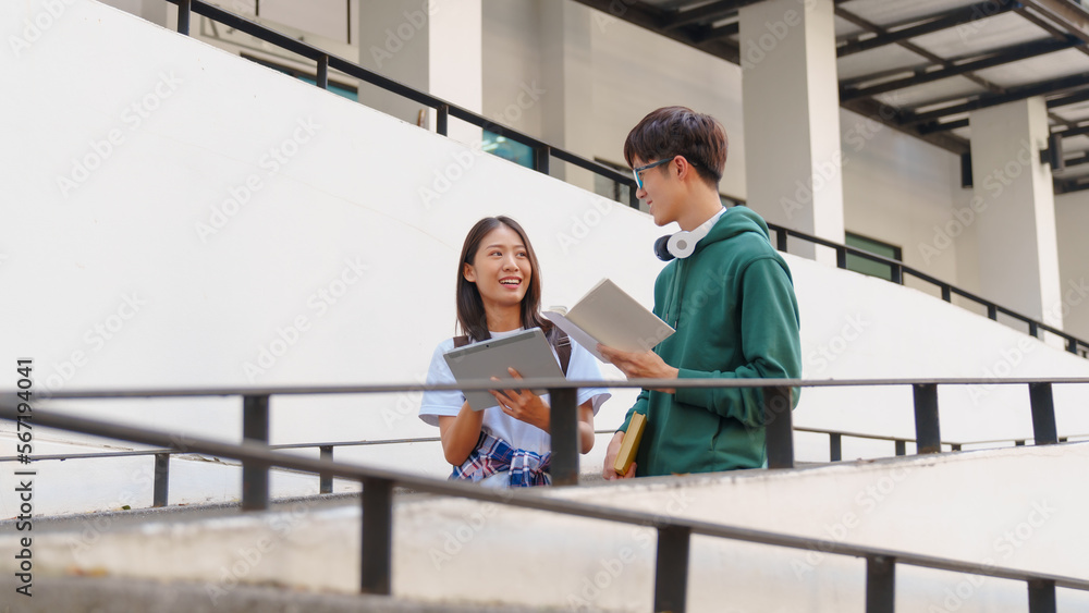Attractive asian college student using laptop and tablet studying with group of friends together with english language classroom, social media and education concept. Attractive asian college student using laptop and tablet studying with group of friends together with english language classroom, social media and education concept.