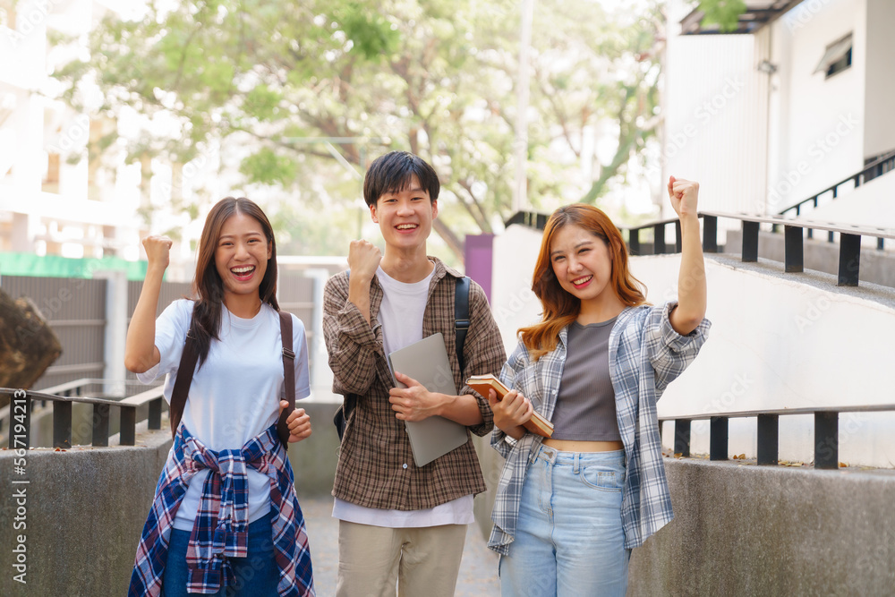 Attractive asian college student using laptop and tablet studying with group of friends together with english language classroom, social media and education concept.