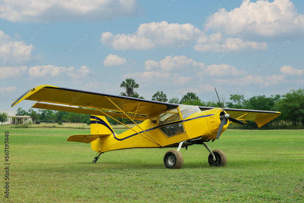 View of beautiful ultralight airplane in field on autumn day View of beautiful ultralight airplane in field on autumn day