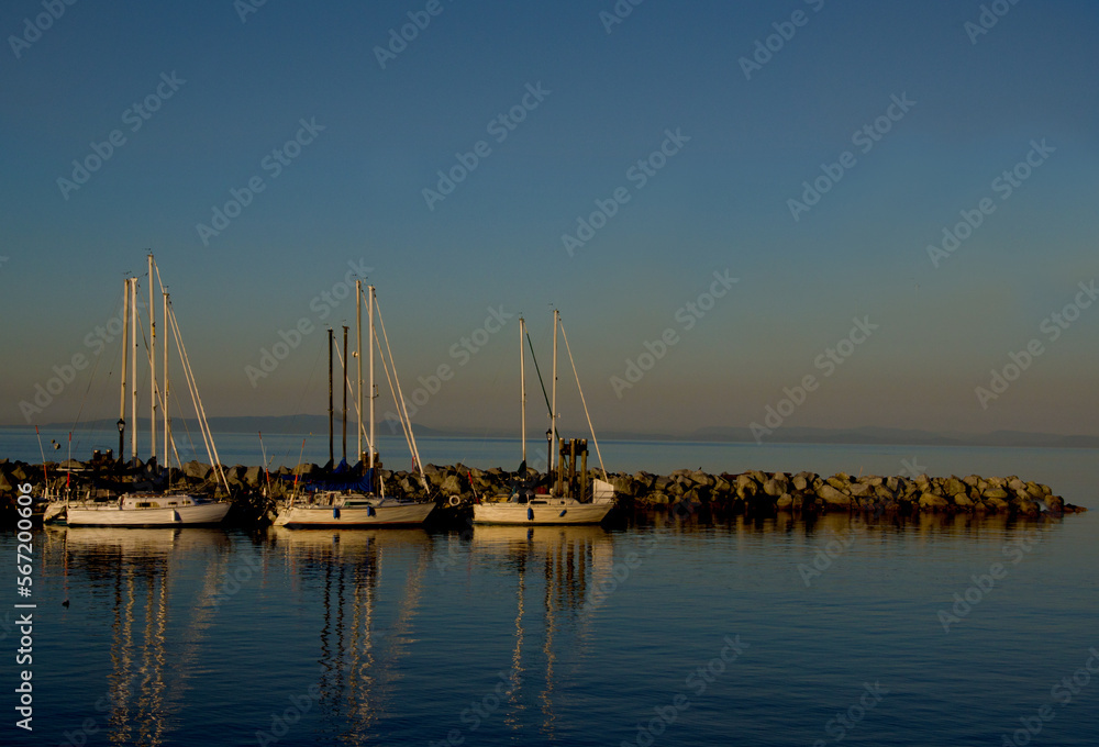 Three sailboats at golden hour with plenty of copy space.