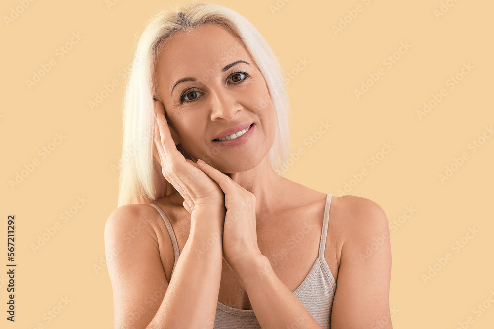Mature blonde woman on beige background Mature blonde woman on beige background