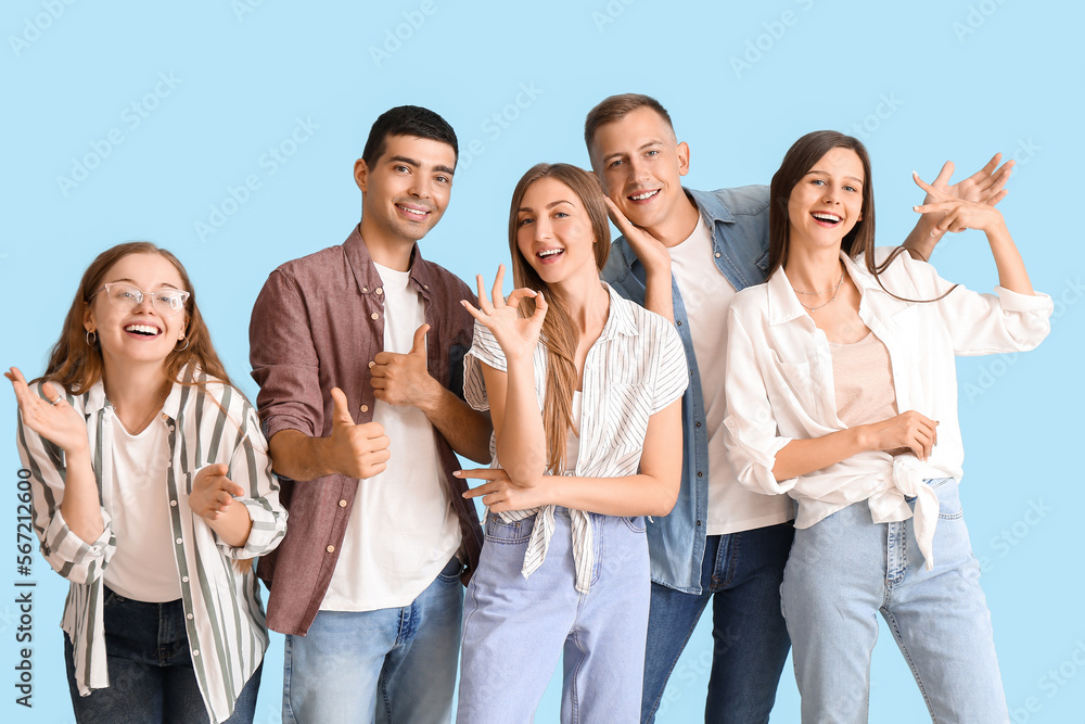 Group of happy friends gesturing on blue background Group of happy friends gesturing on blue background