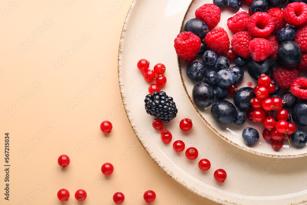 Plate with fresh berries on color background, closeup Plate with fresh berries on color background, closeup
