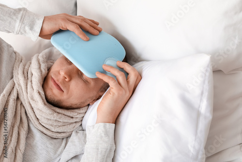 Young man warming his foreh...