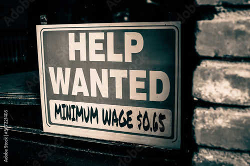 Old vintage photo of help wanted sign from the past with low minimum wage #567221406