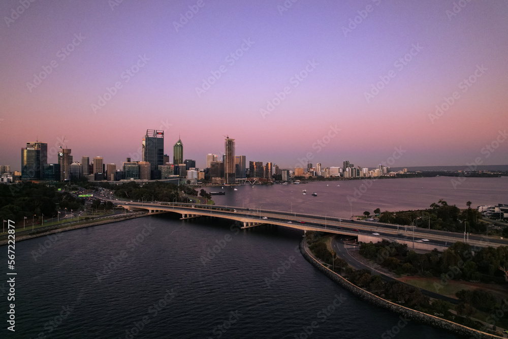 Aerial view of the Narrows bridge across the Swan River and the Perth skyline at sunset.
