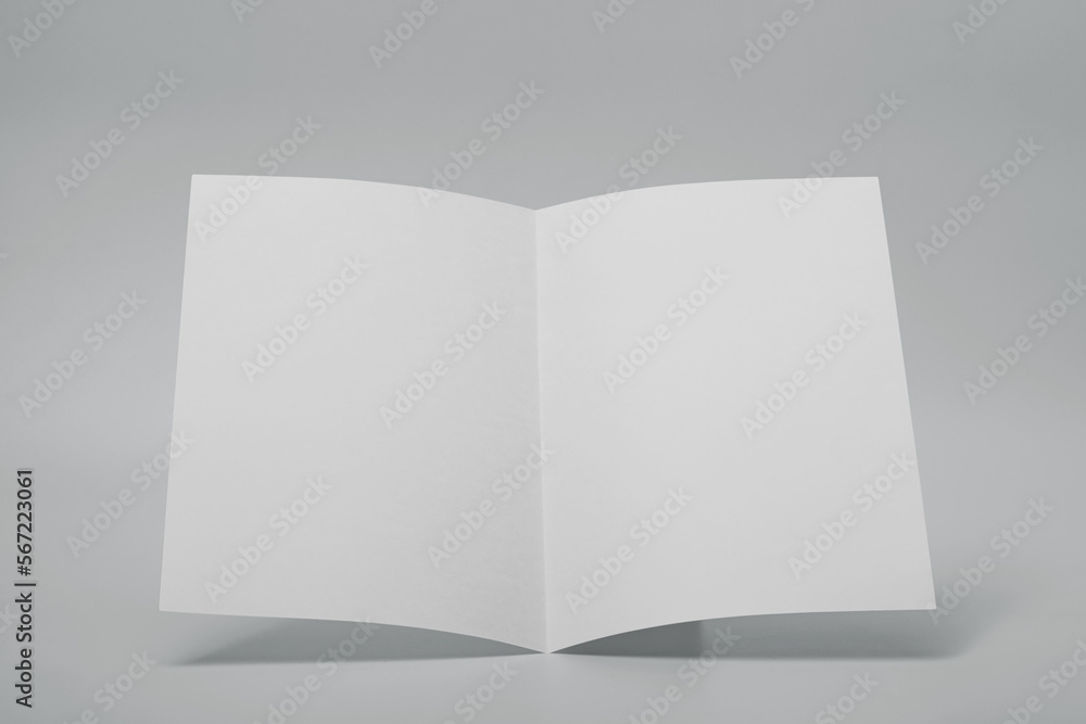 Blank paper folded on gray background Blank paper folded on gray background