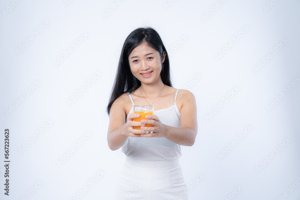 Beautiful asian woman drinking orange juice, healthcare, skin, beauty and wellbeing concepts, isolated on white background Beautiful asian woman drinking orange juice, healthcare, skin, beauty and wellbeing concepts, isolated on white background