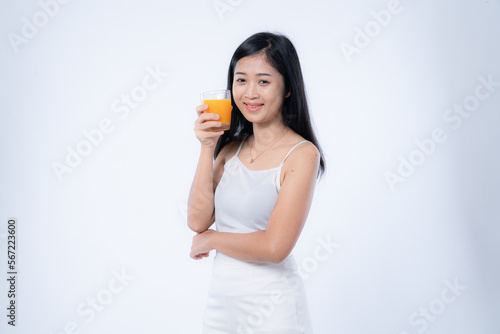 Beautiful asian woman drinking orange juice, healthcare, skin, beauty and wellbeing concepts, isolated on white background