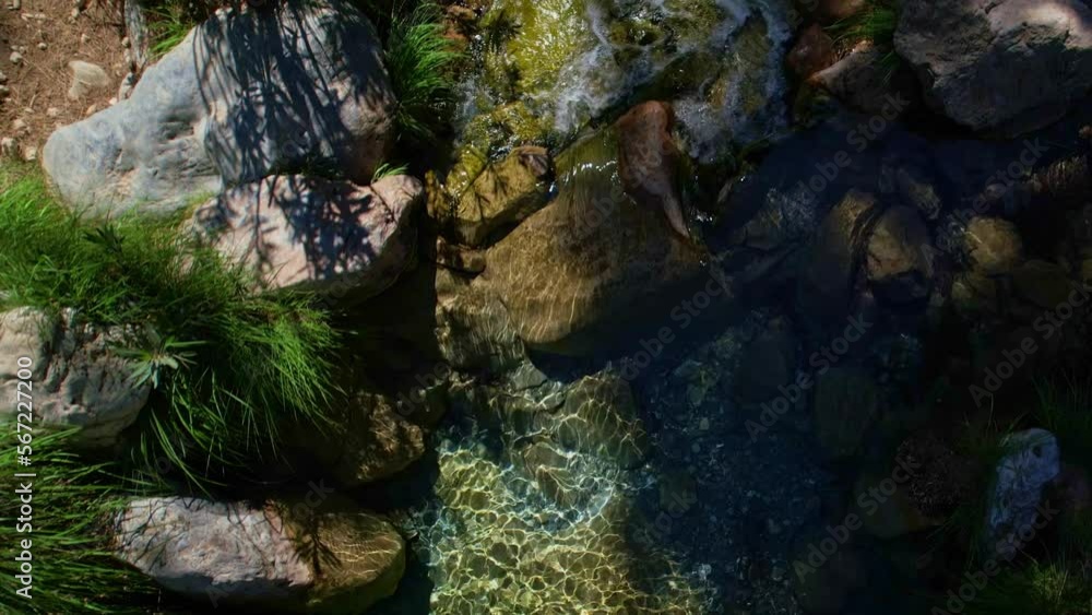 Colorful water in mountain stream. Crystal clear water and purity of natural colors. Aerial flight at a very low level over the water. Rio verde. Granada. Spain. Colorful water in mountain stream. Crystal clear water and purity of natural colors. Aerial flight at a very low level over the water. Rio verde. Granada. Spain.