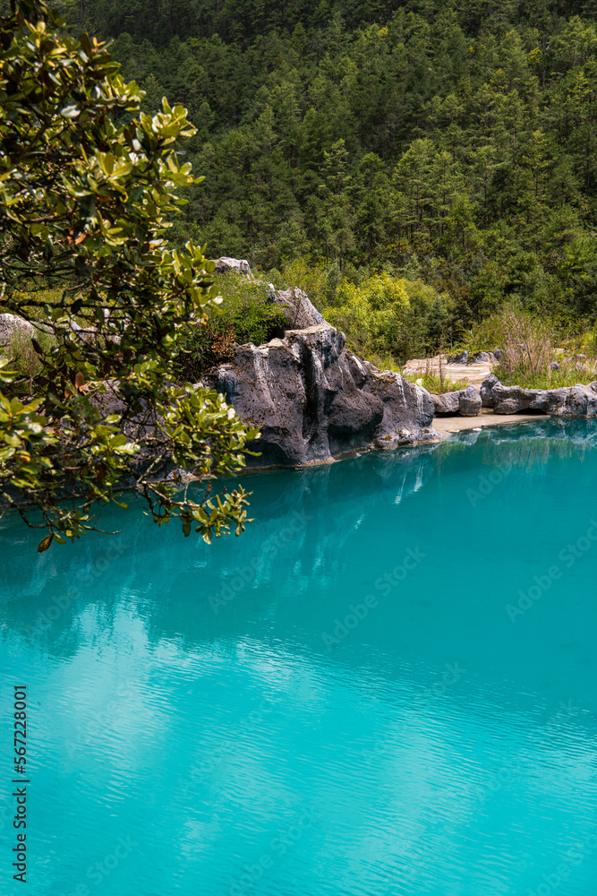 Stone shores of the beautiful turquoise lake in a Blue Moon Valley in Yunnan, China