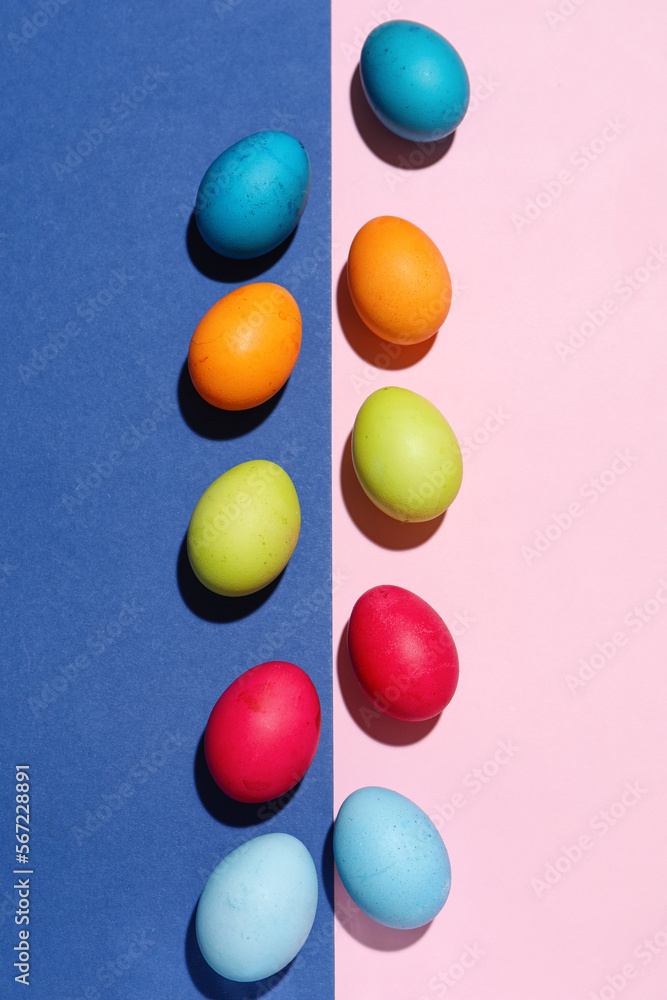 Composition with painted eggs for Easter celebration on color background