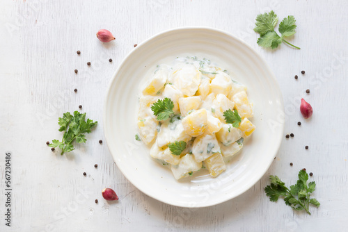 Healthy food potato salad creamy mayonnaise in bowl on wood table top view copy space.
