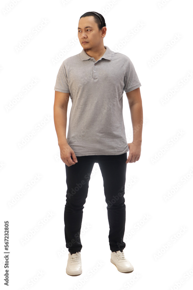 Man wearing casual grey shirt black denim and white shoes, looking to the side, front view. Full body portrait isolated Man wearing casual grey shirt black denim and white shoes, looking to the side, front view. Full body portrait isolated