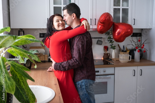 Man and woman in love date at home in kitchen happy hugs. Valentine's Day, happy couple, love story. Love nest, housing for young family
