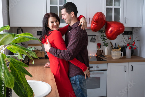 Man and woman in love date at home in kitchen happy hugs. Valentine's Day, happy couple, love story. Love nest, housing for young family