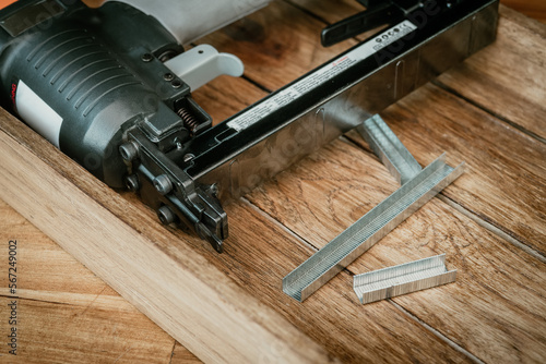Obraz na płótnie Upholstery Stapler with Staples on wooden desk in workshop. Carpentry Woodworking and DIY Projects concept w salonie