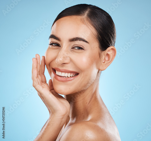 Wall Mural Portrait, smile and skincare with a model woman in studio on a blue background for natural beauty