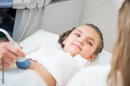 Doctor ultrasound examines little girl belly