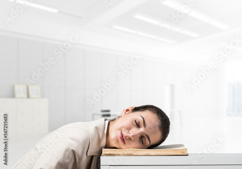 Exhausted business woman sleeping on desk
