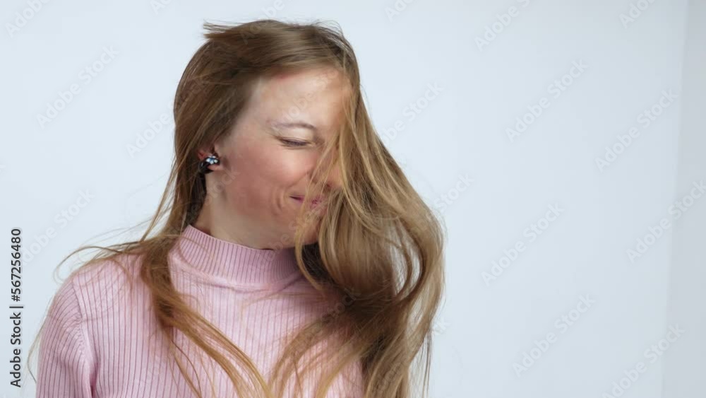 Young woman shaking her head and make her hair dance. Young woman shaking her head and make her hair dance.