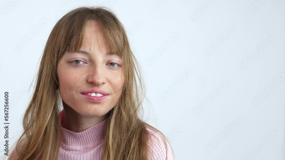 Portrait of a young brunette with a messy hair isolated on white background. Girl shaking head and smiling Portrait of a young brunette with a messy hair isolated on white background. Girl shaking head and smiling