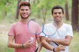 two men are playing badminton