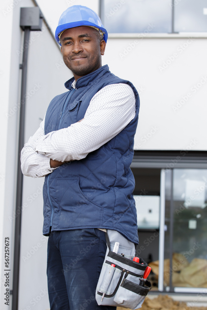 a candid male builder smiles at the camera a candid male builder smiles at the camera