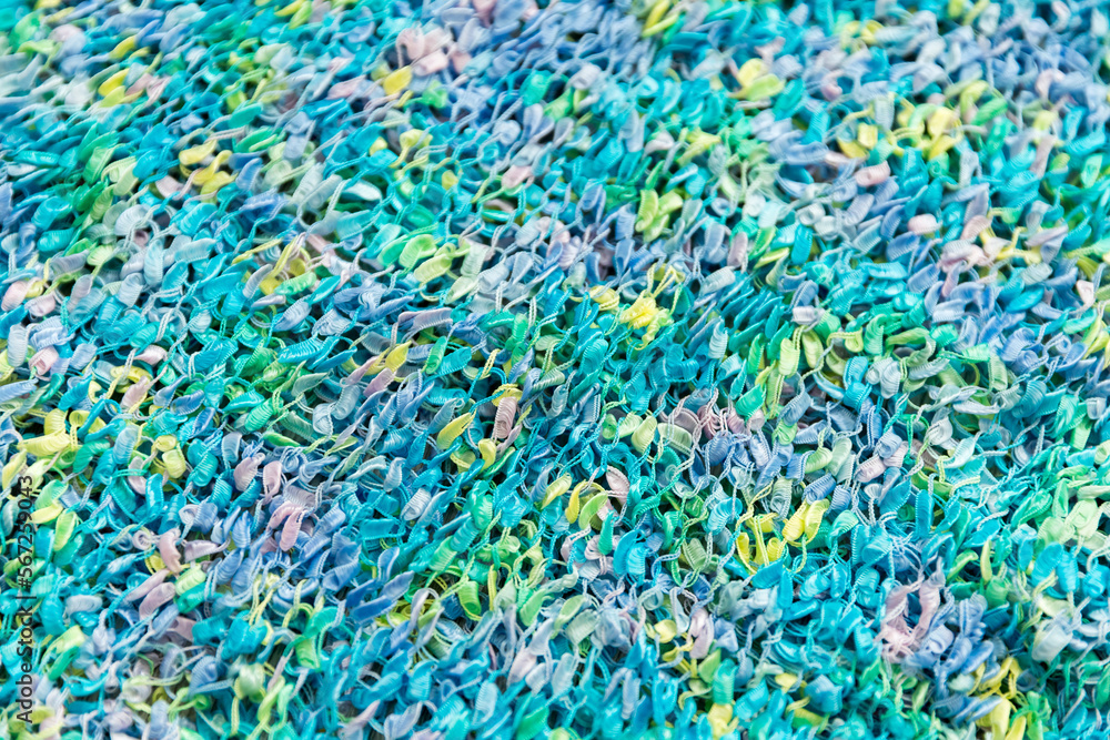 Defocused blurred multicolored blue, pink and yellow fantasy fabric as a background