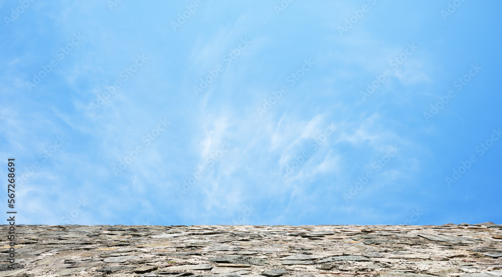 Blue cloudy sky clouds on roof or stone wall background. natural backdrop. Blue cloudy sky clouds on roof or stone wall background. natural backdrop.