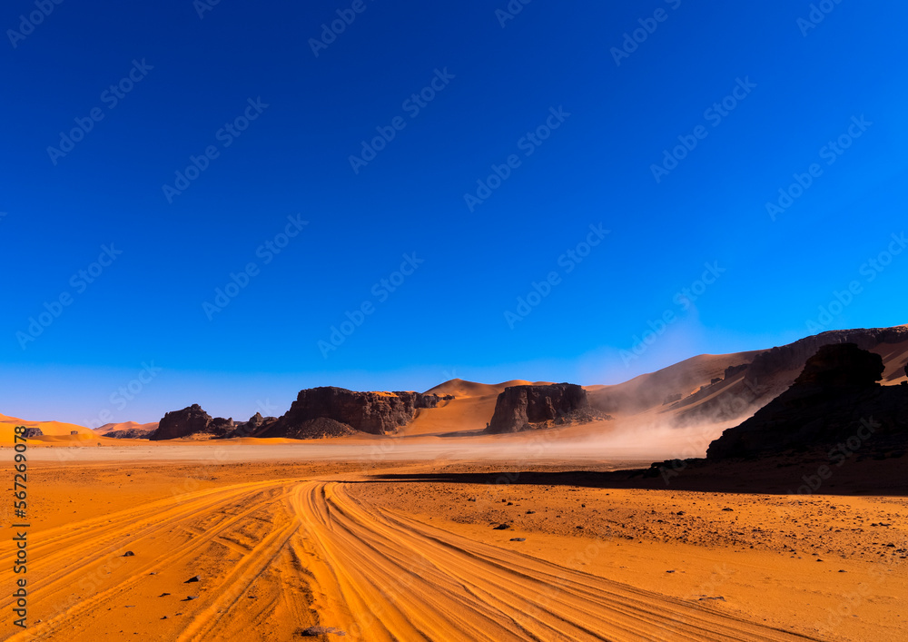 Car tire marks in the sand in Sahara desert, Tassili N'Ajjer National Park, Tadrart Rouge, Algeria Car tire marks in the sand in Sahara desert, Tassili N'Ajjer National Park, Tadrart Rouge, Algeria