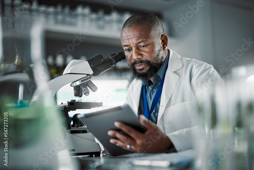 Black man thinking, science and tablet for online research, laboratory and healthcare sample. African American male, scientist or research in lab, digital data and update experiment results and focus